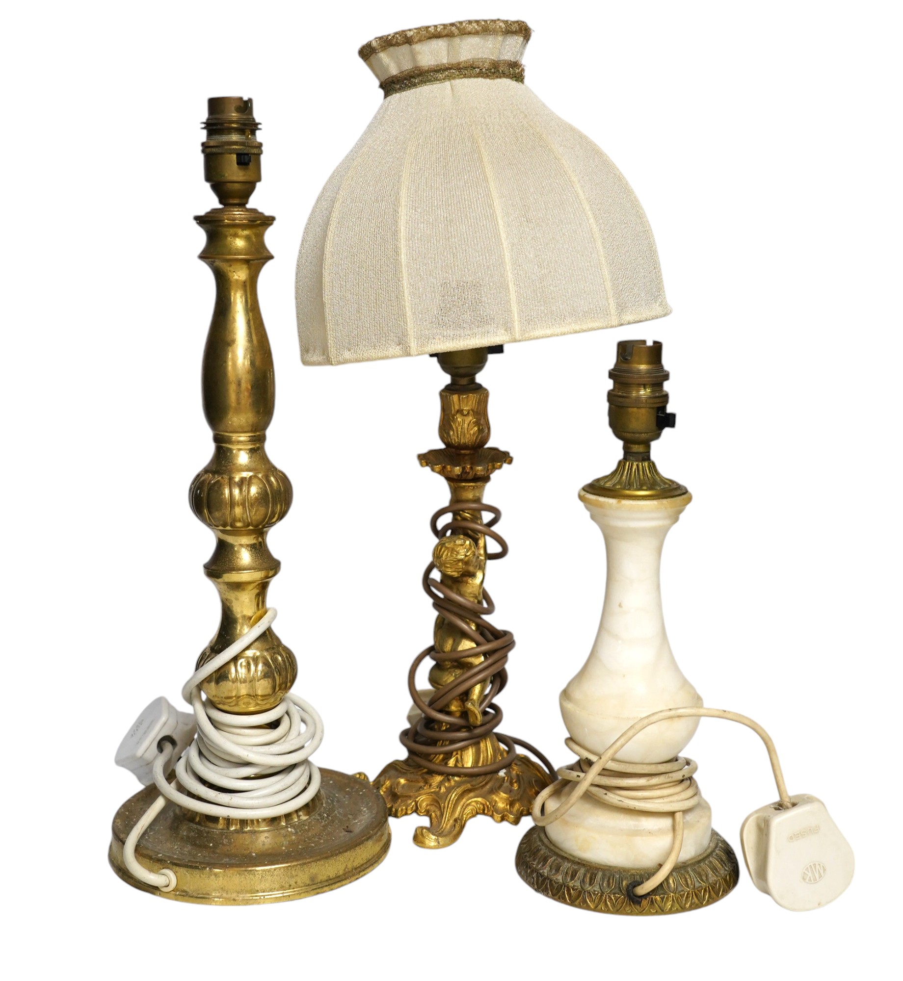 A figurative gilt metal table lamp, five brass table lamps and an alabaster lamp, tallest 35cm high. Condition - one poor, the others fair to good